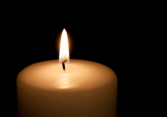 White candle on black background with copy space for text