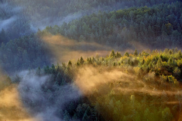 sunrise beams over fog in the Bohemian Switzerland