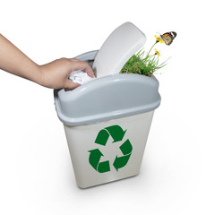 hand putting a paper garbage into recycling bin