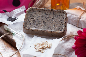 Bar of homemade soap with oatmeal and poppy