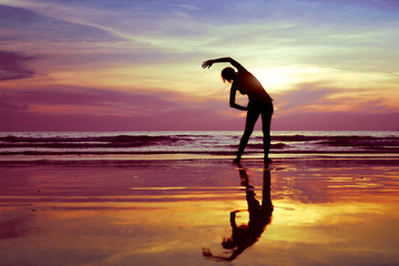 stretch before gym on the beach, silhouette of woman