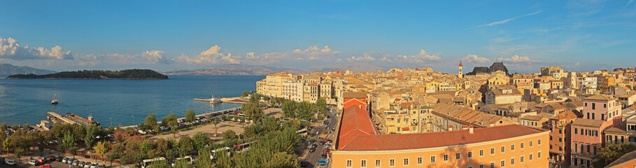 Fototapeta premium Panoramic shot of Corfu city with blue cloudy sky. Sen from abov