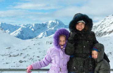 Family on winter mountain background (Austria).