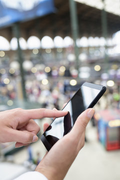 Close up of hands woman using her cell phone in station, backgro
