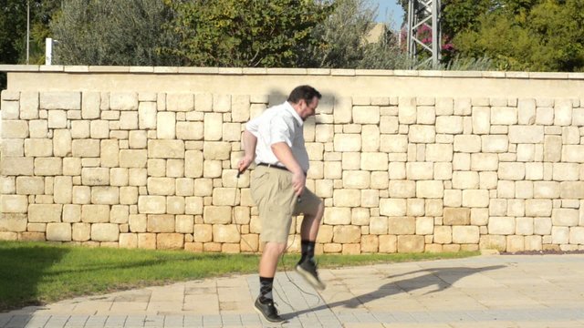 Fat man trying jump on the rope