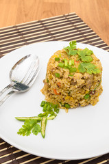 Fried rice yellow curry with pork on bamboo mat