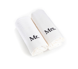 mr and mrs rolled white towels isolated on a white background