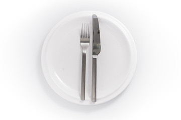 stainless knife and fork in a chine plate isolated on a white ba