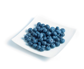 blueberries on a plate isolated on a white background