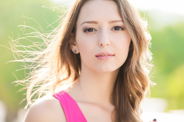 portrait of attractive young woman wearing pink dress
