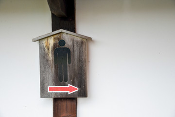 Toilet sign in wooden board