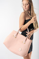 Beautiful belonde girl with pink bag