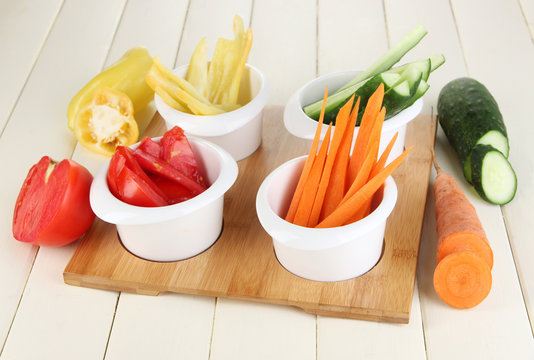 Bright fresh vegetables cut up slices in bowls
