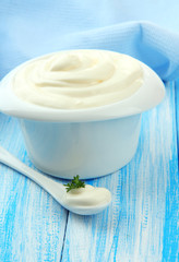 Sour cream in bowl on table close-up