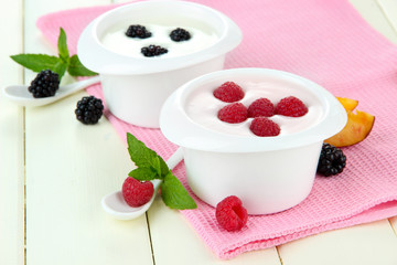 Delicious yogurt with fruit and berries on table close-up