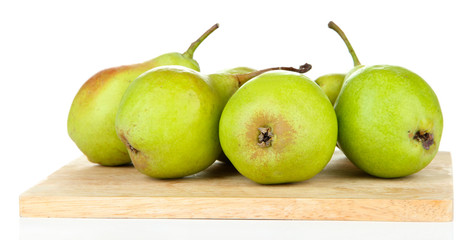 Pears on wooden cutting board, isolated on white