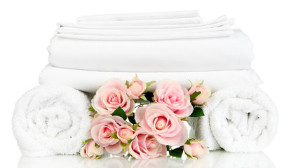 Stack of clean bedding sheets and towels isolated on white