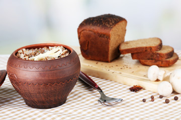 Buckwheat in pot with bread closeup