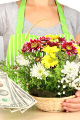 Florist makes flowers bouquet in wicker basket