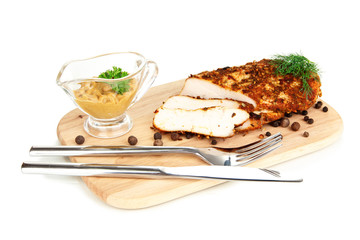 Roasted chicken fillets on wooden board, isolated on white