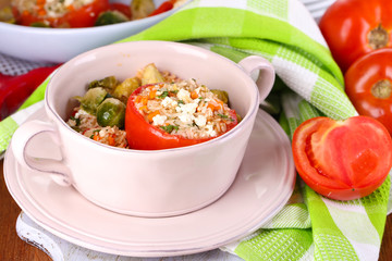Stuffed tomatoes in pan on wooden table close-up