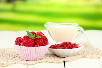 Fresh raspberry, raspberry jam and cream in jug