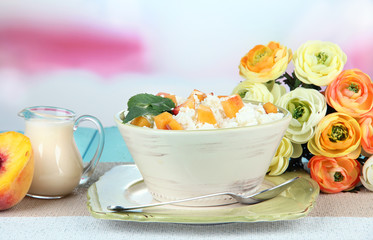 Sour cheese and pieces of fresh peach,on wooden table,