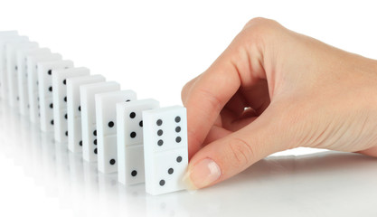 Hand playing domino isolated on white