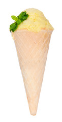 Fototapeta na wymiar Appetizing yellow ice cream with mint in waffle cone isolated