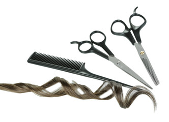 Shiny brown curl with scissors and comb isolated on white