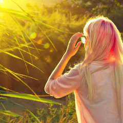 Young girl with pink hair and modern look in summer park