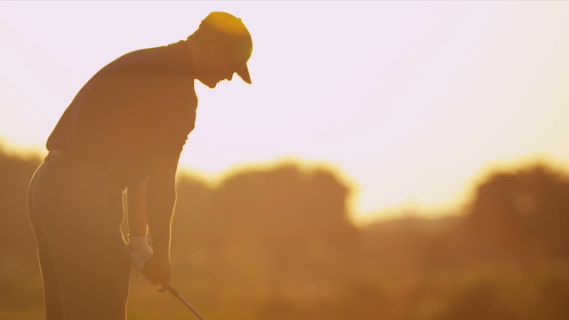 Professional Golfer Sunset Teeing Off 