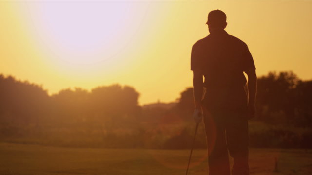 Caucasian Male Playing Golf Course Sunset