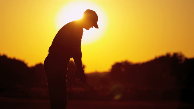 Golfer Driving Off Sunset Golf Resort Fairway