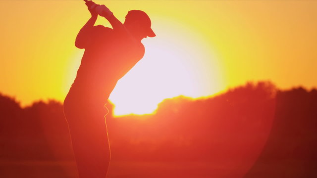 Golfer Driving Off Sunset Golf Resort Fairway