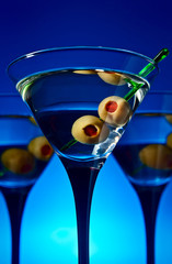 glasses with martini and green olives
