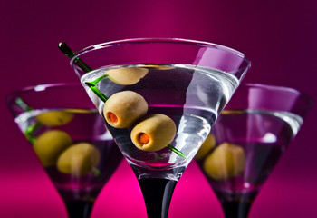 glasses with martini and green olives