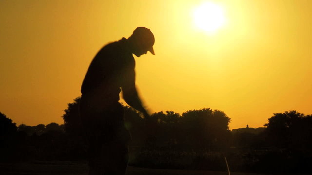 Golfer Driving Off Sunset Golf Resort Fairway