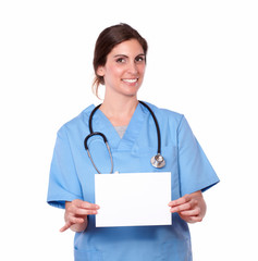 Charming nurse holding a blank card