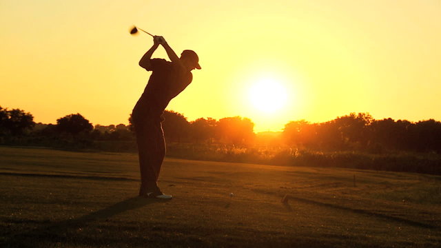 Sunset Golfer Driving Off Golf Resort Fairway