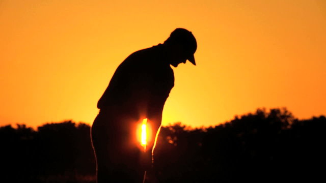 Golfer Driving Off Sunset Golf Resort Fairway 