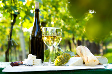 Two glasses of white wine and bottle
