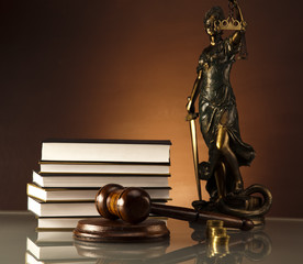 Statue of Lady Justice, gavel and books, gold coins