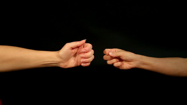 two female hands are playing rock, paper, scissors
