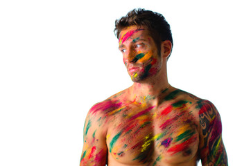 Fototapeta premium Athletic young man shirtless, skin painted with Holi colors