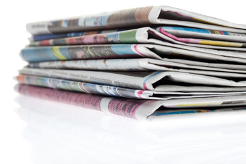 Newspapers folded and stacked concept