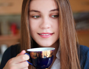 Girl with a cup of drink in hand