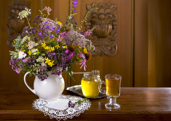 Still life from medicinal herbs, honey, herbal tea on a wooden