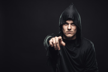 guy in the black robe indicates you