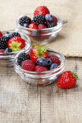 Fruit salad in small transparent bowls on wooden table